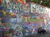 A couple resting by the famous Lennon´s Wall